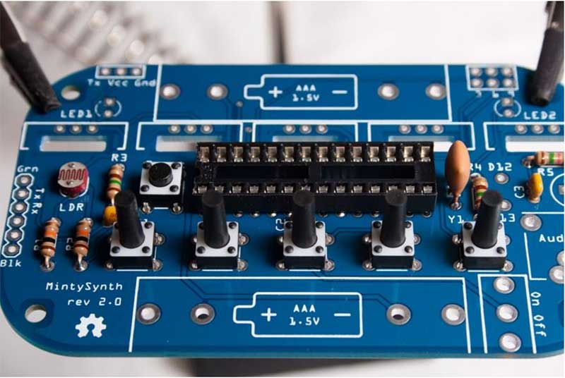 Snap buttons into place, solder, and clip all leads